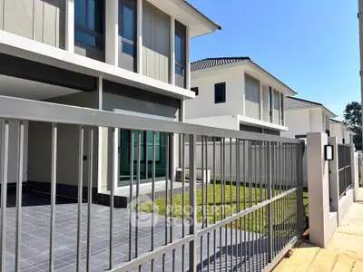 Modern residential building with sleek design and spacious outdoor area.