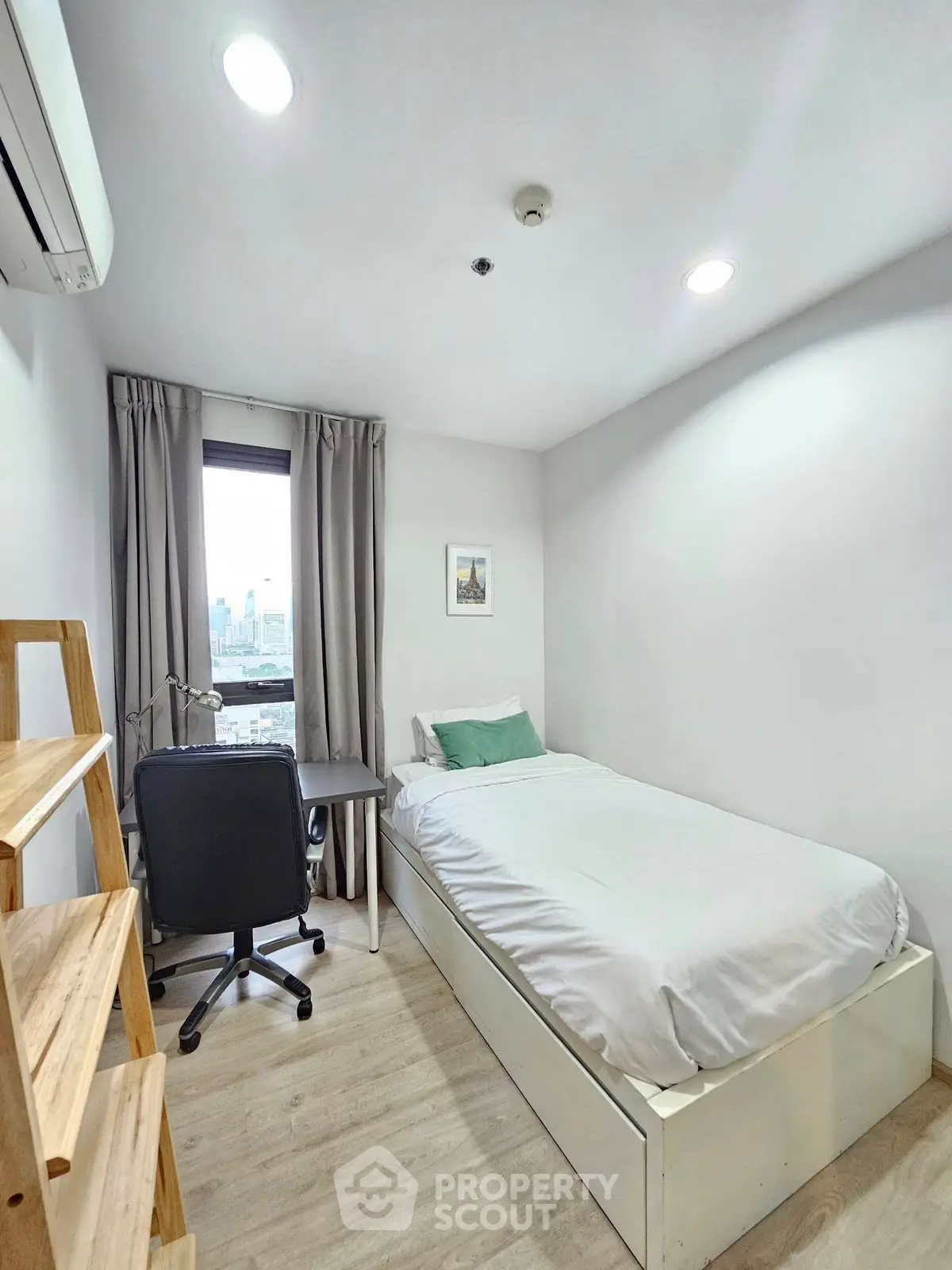 Cozy minimalist bedroom with city view, perfect for urban living.