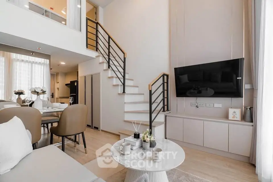 Modern duplex living room with elegant decor and open dining area