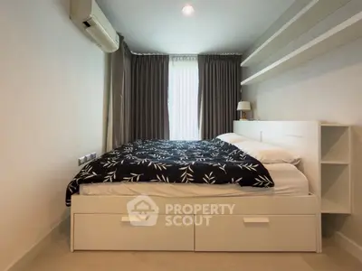 Modern bedroom with stylish decor and ample natural light, featuring a comfortable bed and sleek storage solutions.