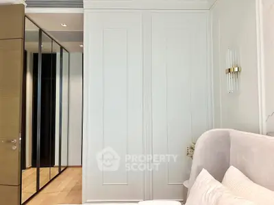 Luxurious bedroom with elegant decor and mirrored closet doors