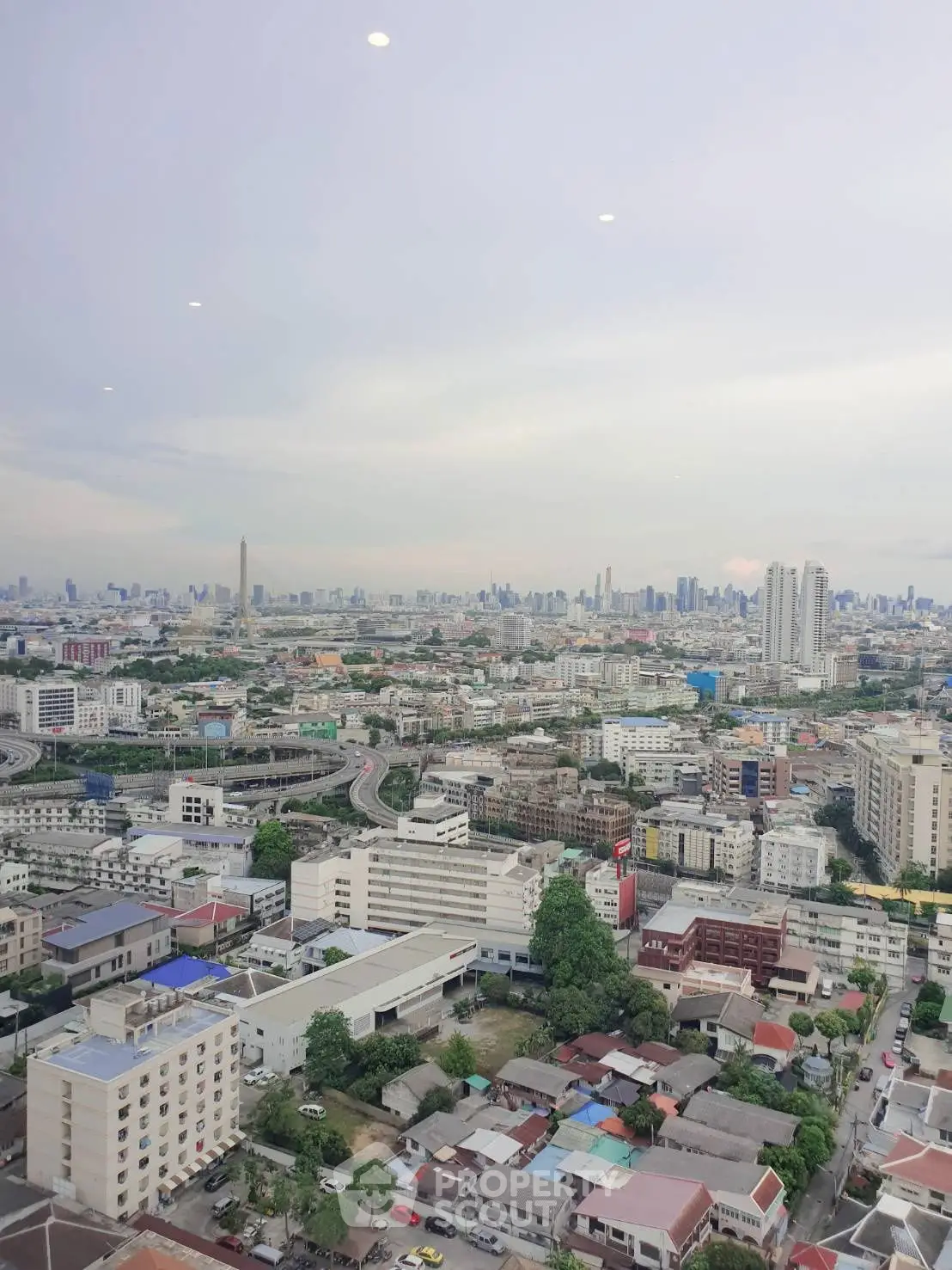 Stunning cityscape view from high-rise building showcasing urban skyline and vibrant city life.