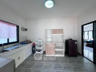 Spacious kitchen with modern cabinetry and ample natural light.