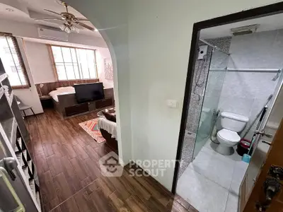 Cozy studio apartment with wooden flooring and modern bathroom