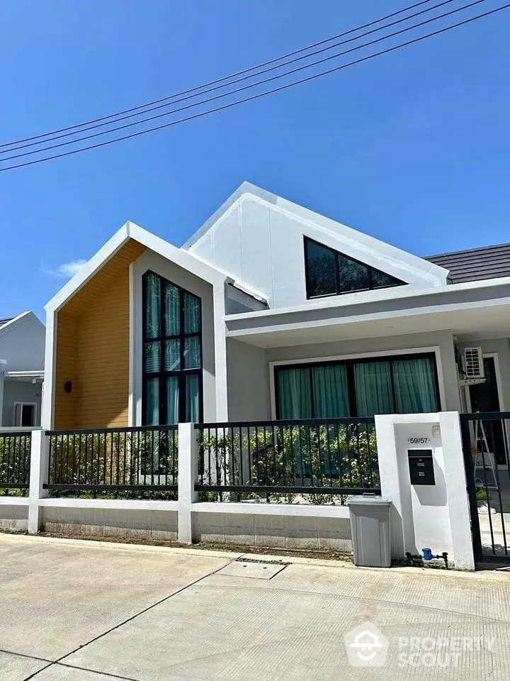 Modern single-story house with unique architectural design and large windows.