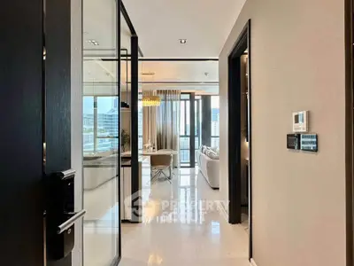 Luxurious modern apartment entrance with glass doors and elegant living area