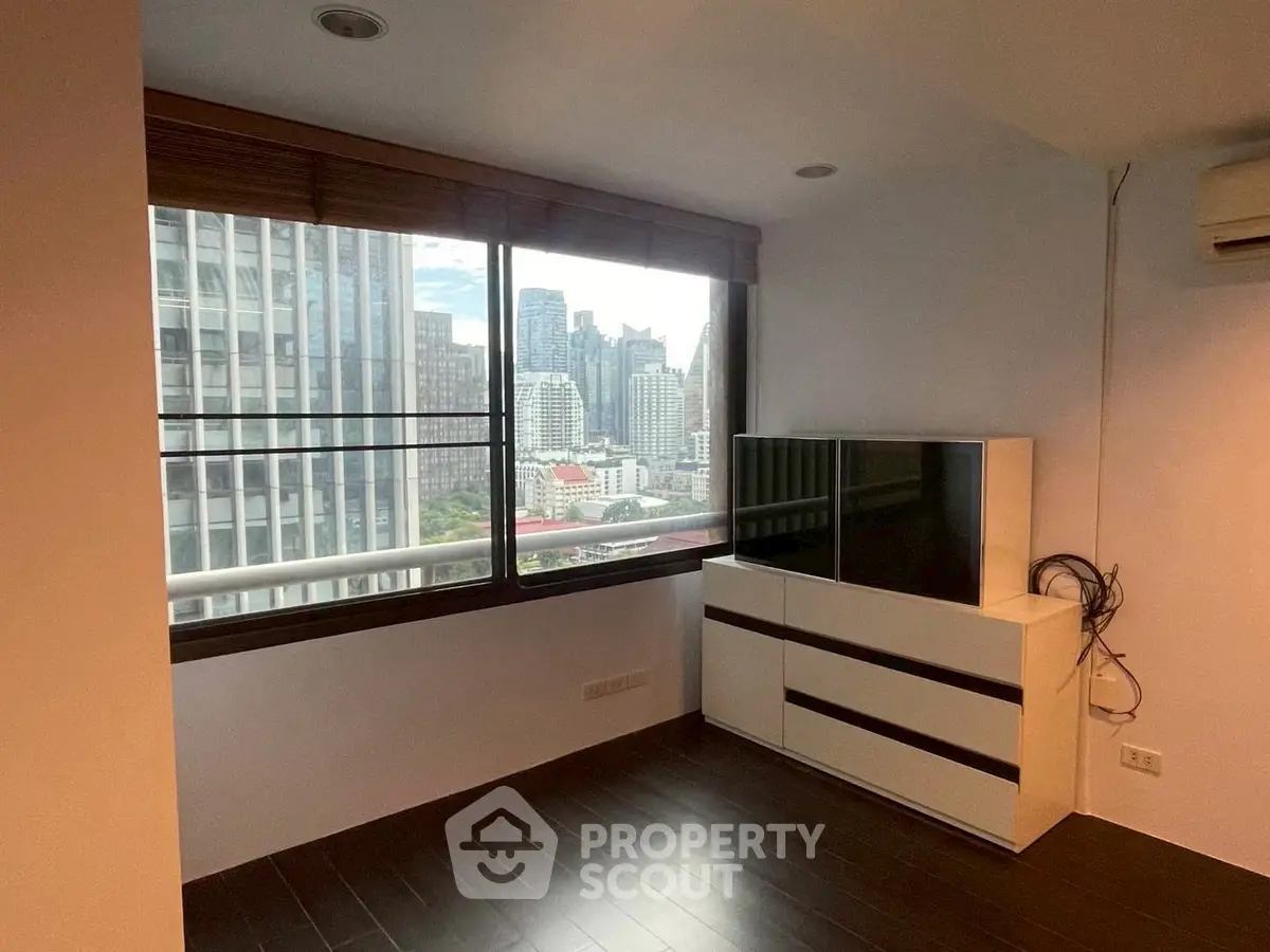 Modern living room with city view and sleek furniture