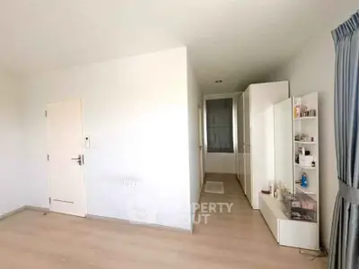 Spacious minimalist bedroom with ample storage and natural light