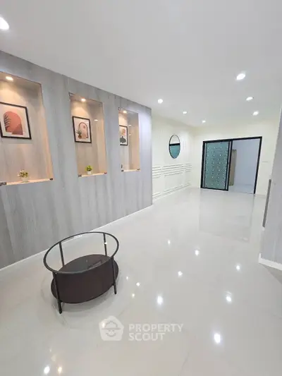 Spacious modern living room with elegant decor and recessed lighting