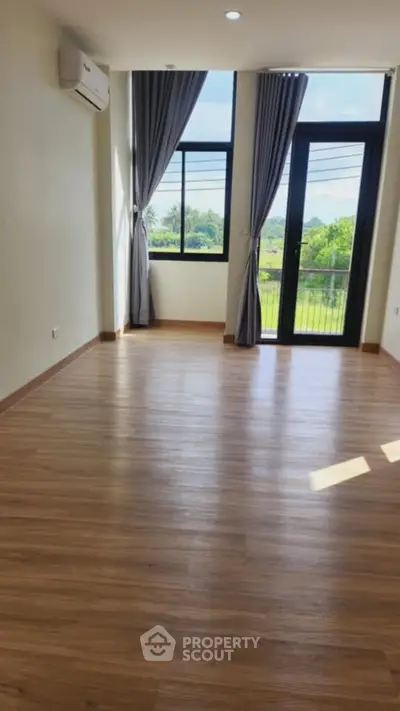 Spacious room with large windows and scenic view, perfect for modern living.