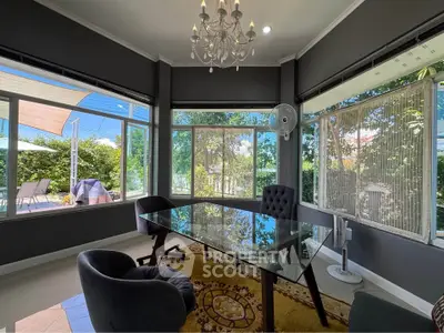 Elegant study room with glass desk and garden view, perfect for work-from-home setup.