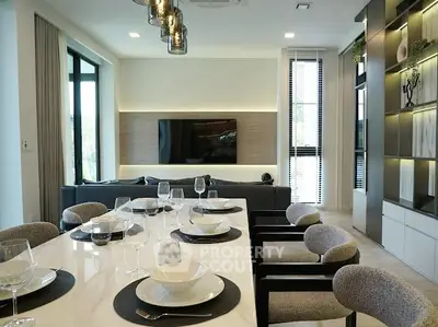 Modern living room with elegant dining area and stylish decor