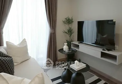 Modern living room with stylish decor, featuring a sleek TV setup and cozy seating area.