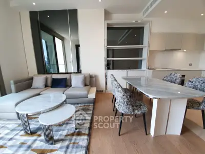 Modern living room with elegant dining area and stylish furniture in a luxury apartment.
