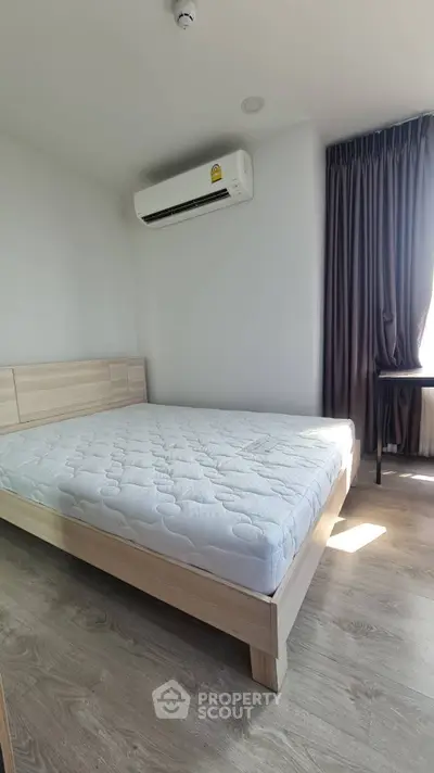 Modern bedroom with natural light and air conditioning in a minimalist style.