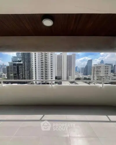 Spacious balcony with stunning city skyline view, perfect for urban living.