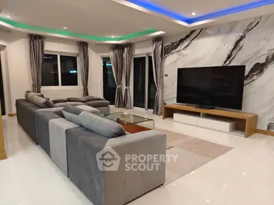 Luxurious modern living room with marble accent wall and large TV