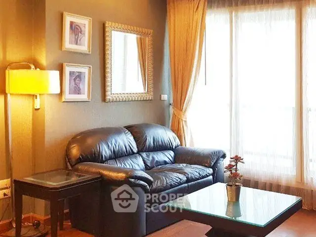 Cozy living room with leather sofa and elegant decor in bright apartment.