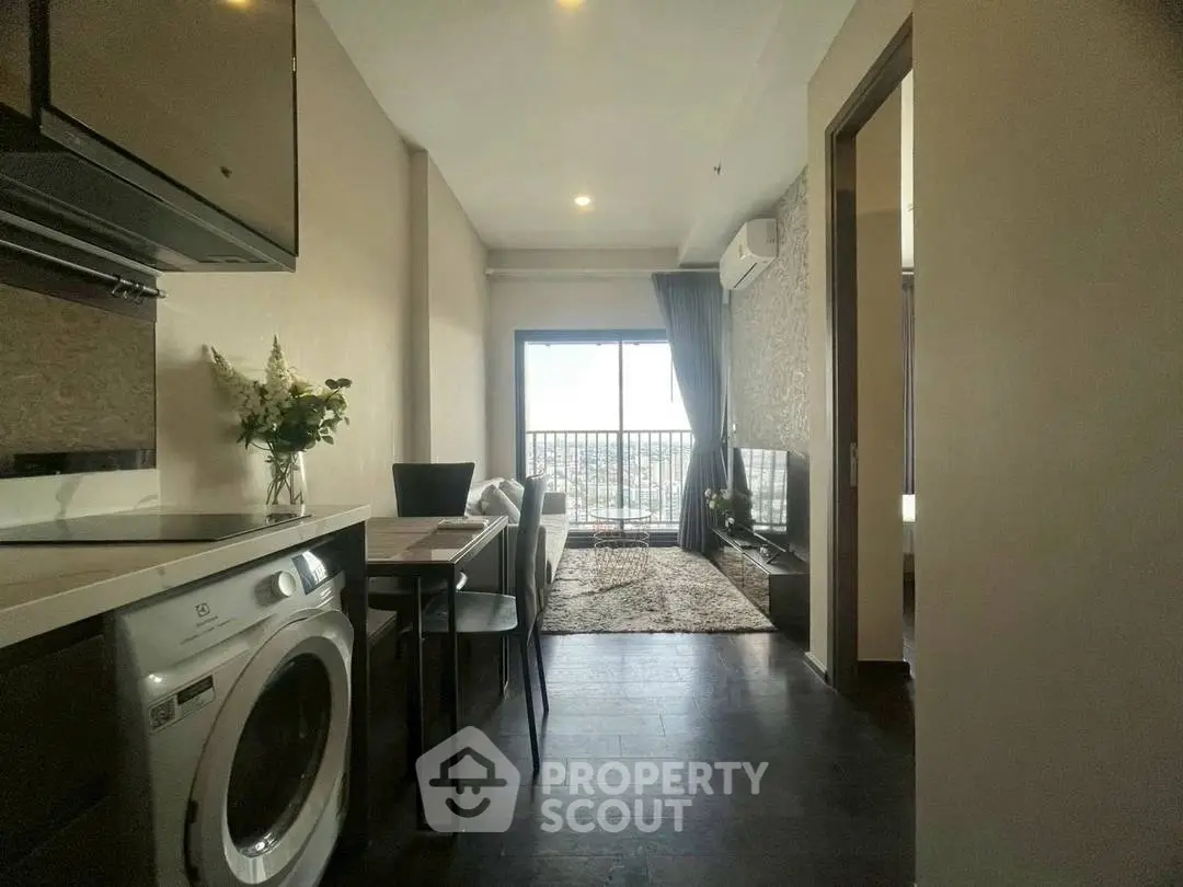 Modern apartment with open kitchen, living area, and balcony view