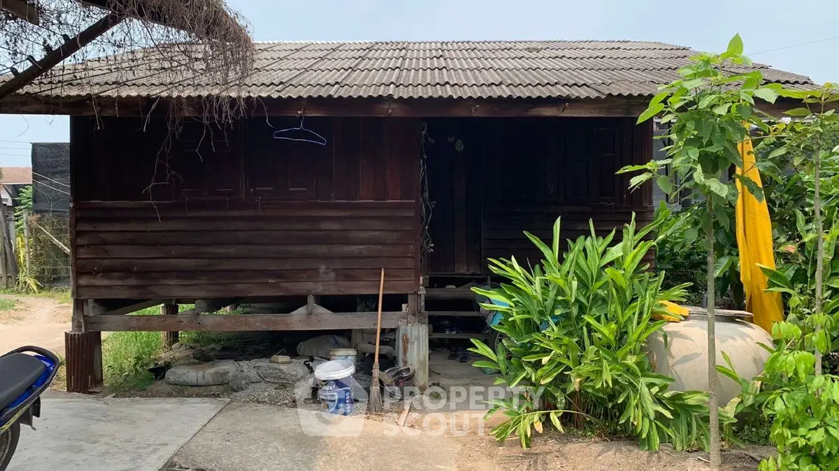 Charming rustic wooden house with lush greenery and traditional design.