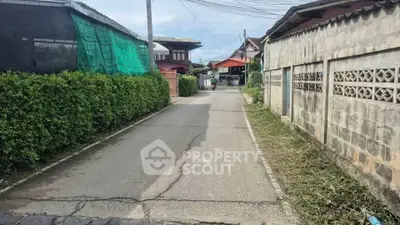Charming residential street with lush greenery and traditional homes, perfect for serene living.
