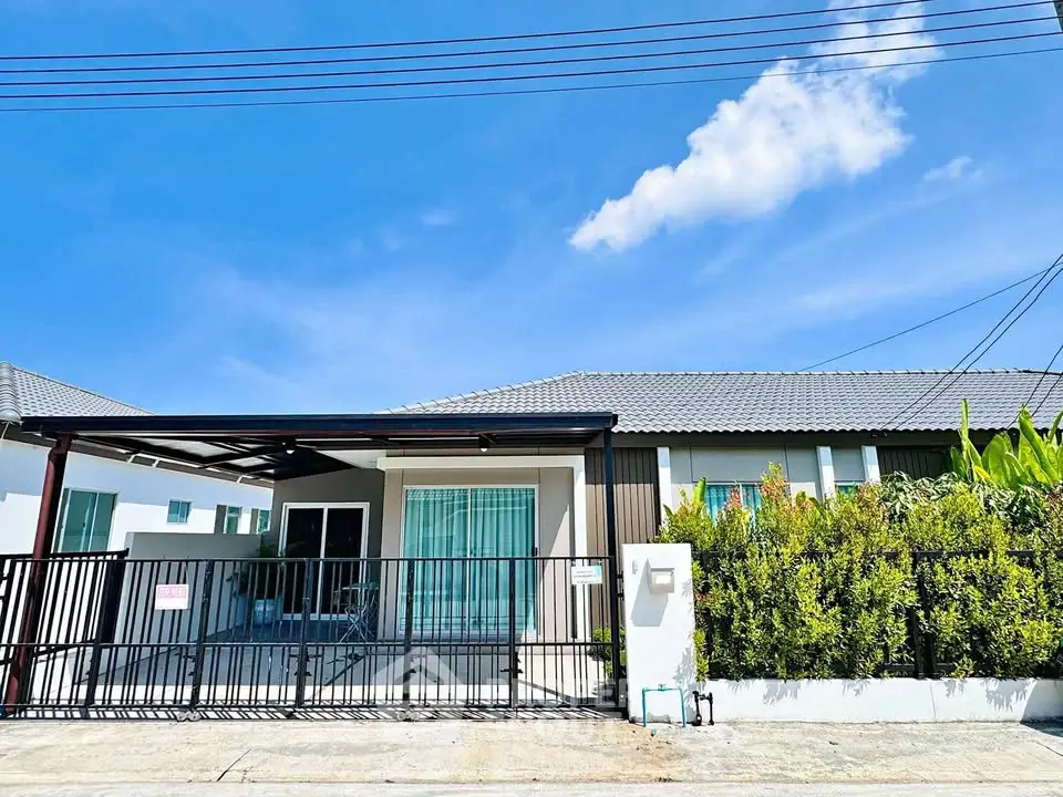 Charming single-story home with modern facade and lush greenery, perfect for family living.