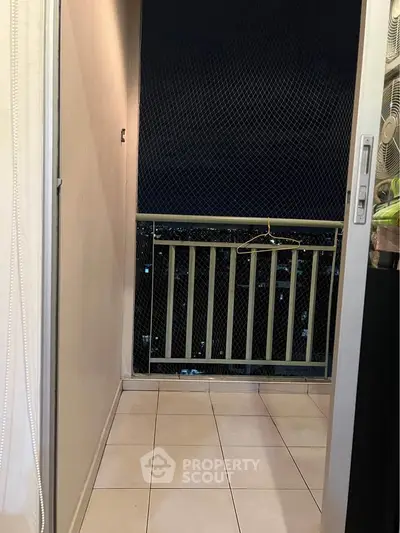 Cozy balcony with night view, perfect for relaxation and enjoying city lights.