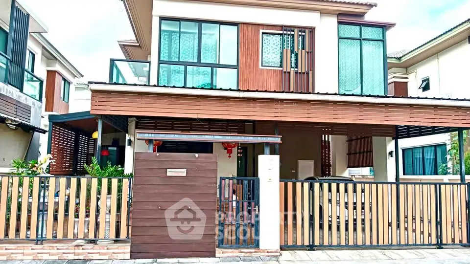 Modern two-story house with stylish facade and spacious balcony in a serene neighborhood.