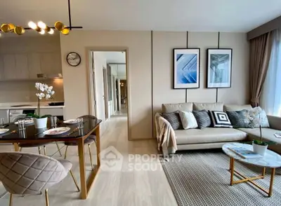 Modern living room with stylish decor and open kitchen layout, perfect for contemporary living.