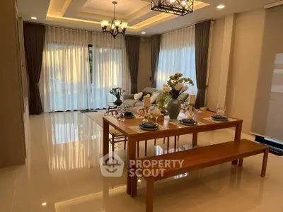 Elegant dining and living area with modern decor and large windows for natural light.