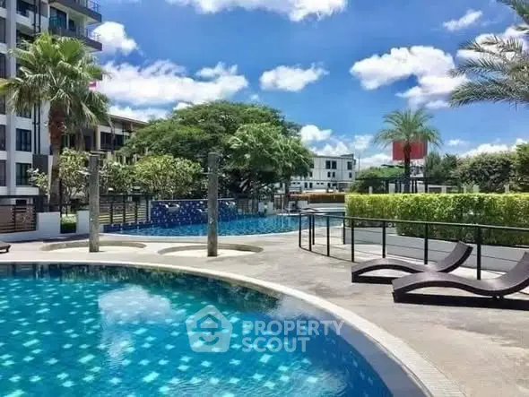 Luxurious residential complex with a stunning outdoor pool and lush greenery, perfect for relaxation.