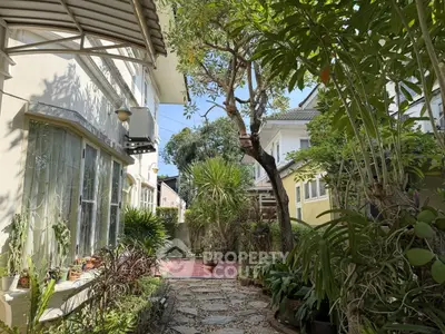 Charming garden view with lush greenery and pathway in a residential property
