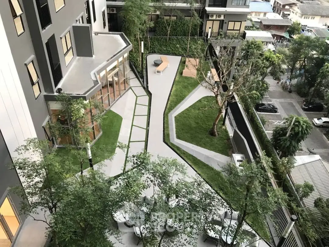 Modern apartment building with landscaped garden and seating area