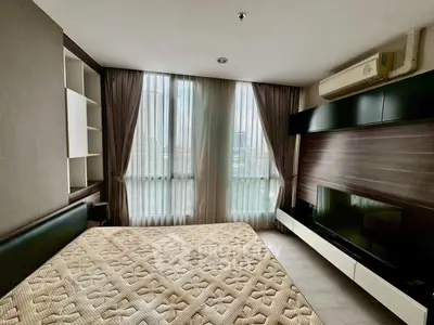 Modern bedroom with large windows and stylish built-in storage