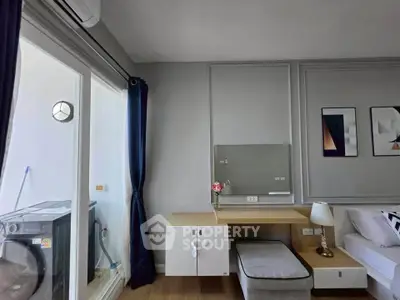 Modern living room with stylish decor and balcony access