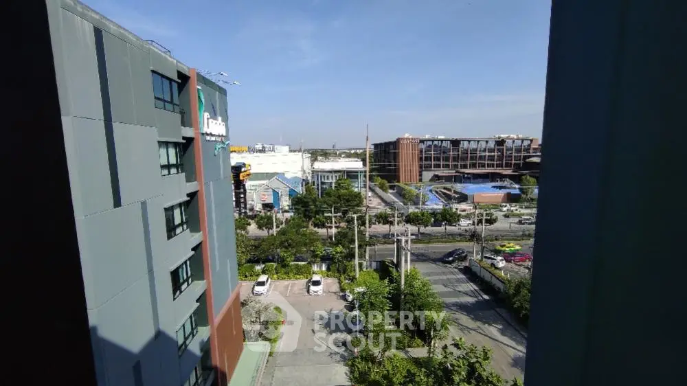 Stunning urban view from high-rise building with clear skies and modern architecture.
