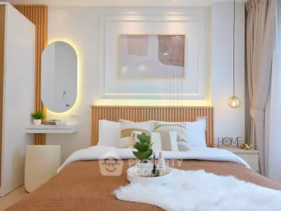 Modern bedroom with stylish decor, featuring a cozy bed, elegant lighting, and a chic wall mirror.