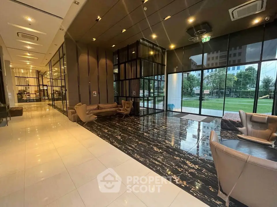 Luxurious modern lobby with elegant seating and floor-to-ceiling windows offering garden views.