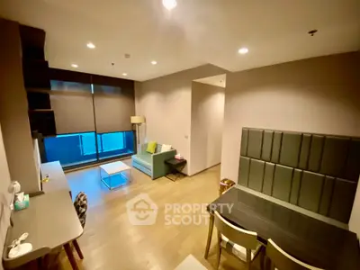 Modern living room with stylish furniture and large window, perfect for urban living.