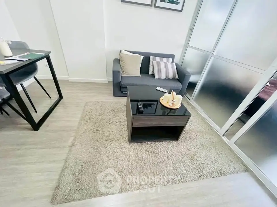 Modern living room with cozy sofa and stylish decor in a bright apartment.