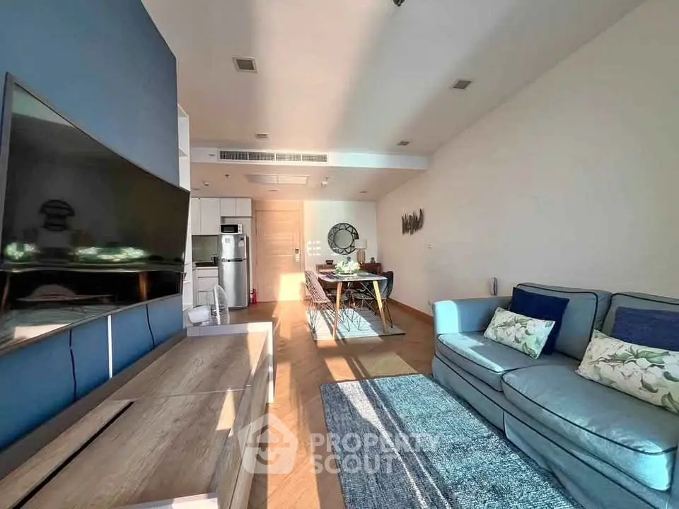 Modern living room with stylish furniture and open kitchen layout