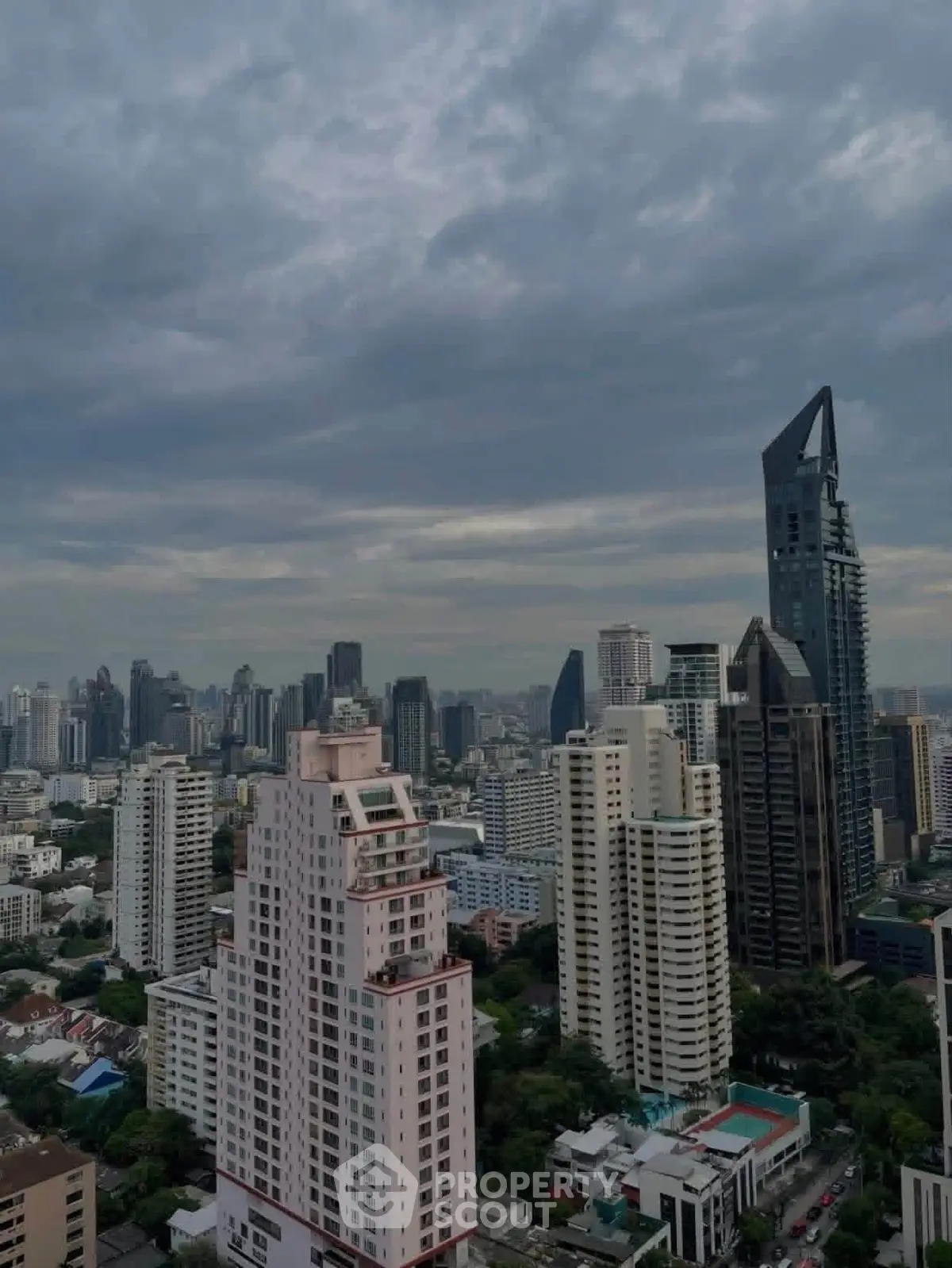 Stunning cityscape view showcasing modern skyscrapers under a dramatic cloudy sky.
