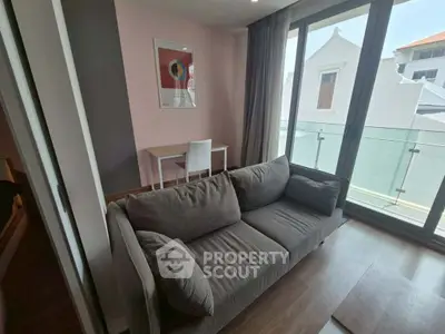 Modern living room with cozy sofa and balcony view in stylish apartment