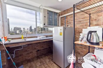 Modern kitchen with city view, featuring stainless steel fridge and open shelving.