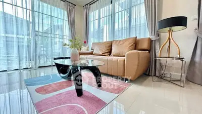 Modern living room with stylish furniture and large windows for natural light.
