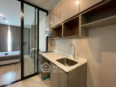 Modern kitchen with sleek cabinetry and open layout in stylish apartment