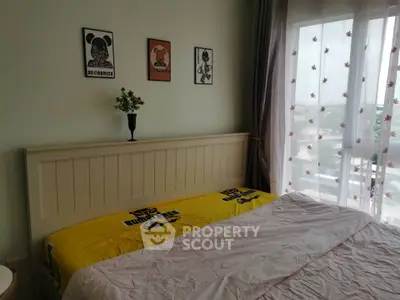 Cozy bedroom with large window and stylish decor in modern apartment