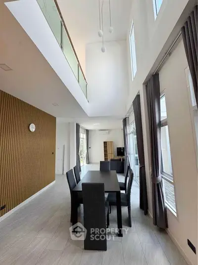 Spacious modern dining area with high ceilings and elegant decor