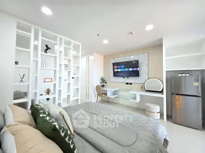 Modern bedroom with stylish decor, built-in shelves, and wall-mounted TV for a luxurious living experience.