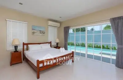 Spacious bedroom with pool view and elegant decor